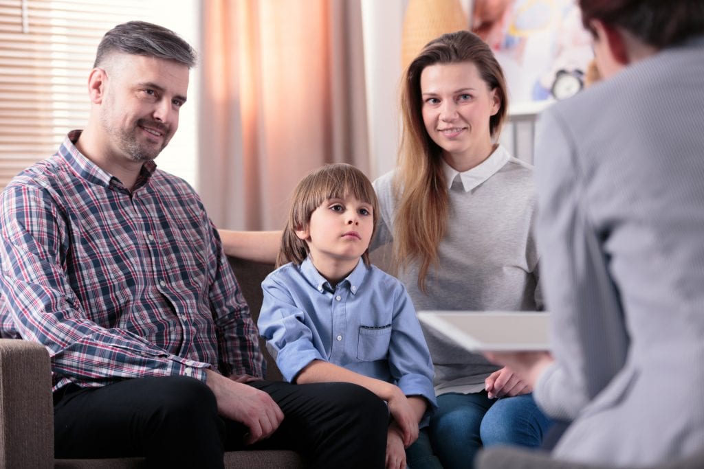 Family meets with counselor to talk about young boys mental health